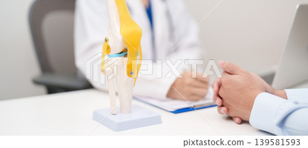 Doctor with Human Knee joint anatomy model. Osteoarthritis, Patellofemoral Pain Syndrome, Patellar Tendinitis, ACL, Anterior Cruciate Ligament, PCL, Posterior, MCL, Medial Collateral, LCL and Lateral 139581593