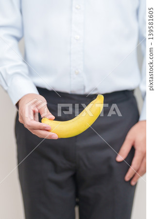 man hand holding Banana. Male Impotence consultation, Prostate Cancer, Enlarged prostate, Prostatitis disease, Infertility, Erectile dysfunction, Reproductive System, Penis and genital disorder man hand holding Banana. Male Impotence consultation, Prostate Cancer, Enlarged prostate, Prostatitis disease, Infertility, Erectile dysfunction, Reproductive System, Penis and genital disorder 139581605