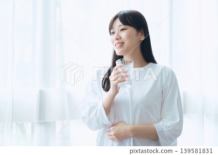 A woman relaxing at the window side A woman relaxing at the window side 139581831