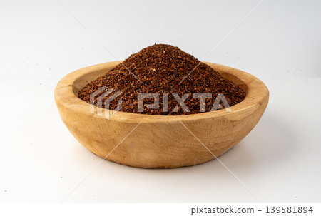Rooibos tea leaves isolated in wood bowl Rooibos tea leaves isolated in wood bowl 139581894