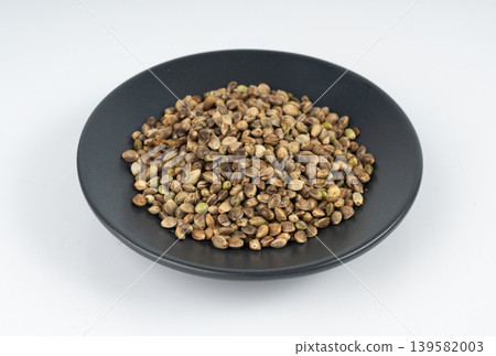 Hemp seeds, cannabis grains, marijuana kernels, oil hempseeds pile Hemp seeds, cannabis grains, marijuana kernels, oil hempseeds pile 139582003