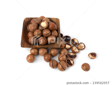 Macadamia nuts isolated. Natural raw peeled macadamia seeds and shells Macadamia nuts isolated. Natural raw peeled macadamia seeds and shells 139582057