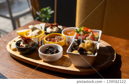 Breakfast appetizer snacks including cheese, hummus, pickled olives Breakfast appetizer snacks including cheese, hummus, pickled olives 139582122