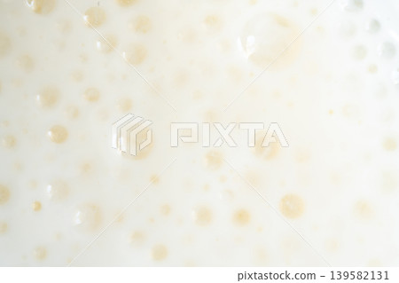 Milkshake texture closeup, white milk shake Milkshake texture closeup, white milk shake 139582131