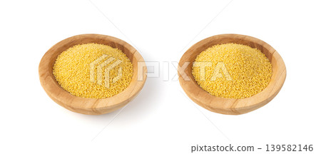 Raw millet grains pile isolated. Little yellow cereal, natural foxtail small seeds Raw millet grains pile isolated. Little yellow cereal, natural foxtail small seeds 139582146