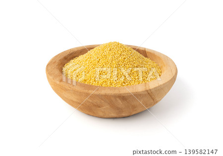 Raw millet grains pile isolated. Little yellow cereal, natural foxtail small seeds Raw millet grains pile isolated. Little yellow cereal, natural foxtail small seeds 139582147