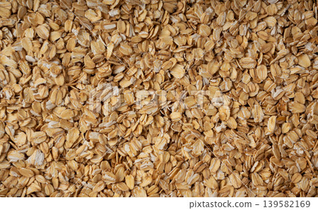 Oat flakes textured pattern, rolled oatmeal macro background 139582169