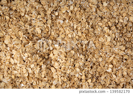 Oat flakes textured pattern, rolled oatmeal macro background Oat flakes textured pattern, rolled oatmeal macro background 139582170