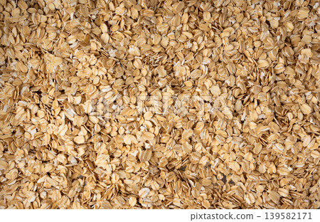 Oat flakes textured pattern, rolled oatmeal macro background 139582171