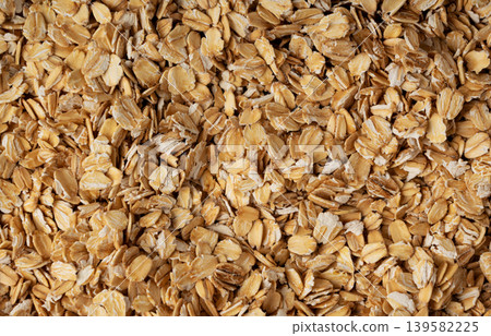 Oat flakes textured pattern, rolled oatmeal macro background Oat flakes textured pattern, rolled oatmeal macro background 139582225
