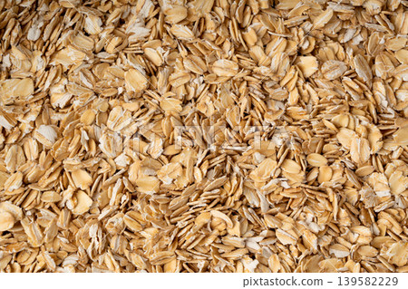 Oat flakes textured pattern, rolled oatmeal macro background 139582229