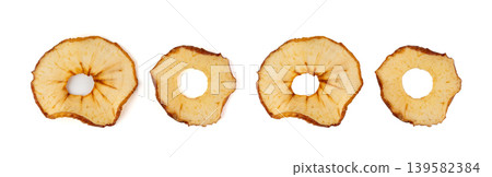 Dry apple slices isolated, dried apple chips, healthy fruit snack Dry apple slices isolated, dried apple chips, healthy fruit snack 139582384