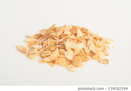Dry Garlic Slices, Crispy Fried Cloves Pile Closeup, Roasted Grilled Garlic Flakes, Clove Chip Group Dry Garlic Slices, Crispy Fried Cloves Pile Closeup, Roasted Grilled Garlic Flakes, Clove Chip Group 139582394