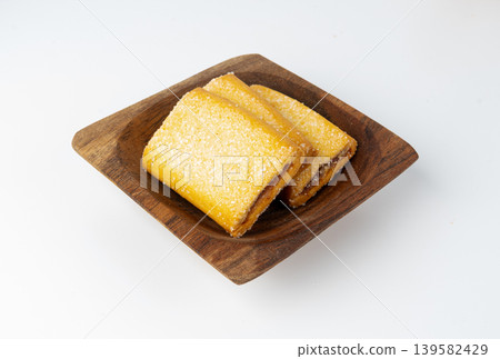 Fig roll bar, square sugar cookies with fruit filling isolated 139582429