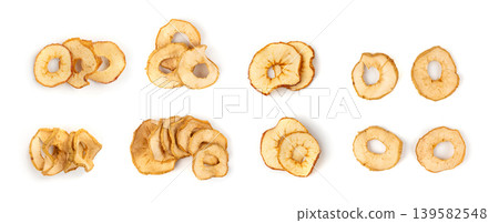 Dry apple slices isolated, dried apple chips, healthy fruit snack Dry apple slices isolated, dried apple chips, healthy fruit snack 139582548