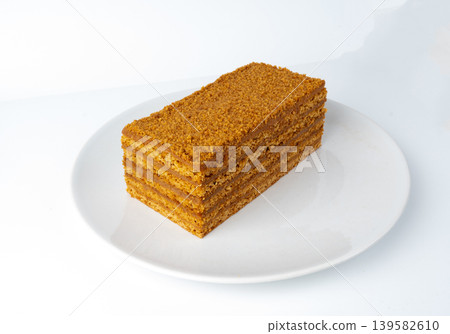 Honey cake isolated, medovik dessert piece Honey cake isolated, medovik dessert piece 139582610