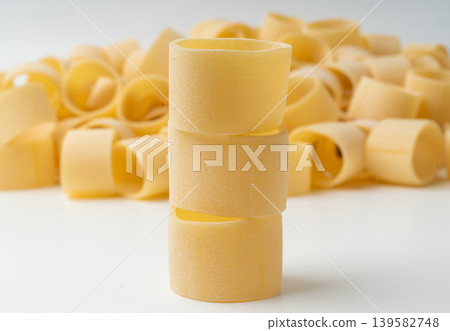 Raw Calamarata Big Pasta Isolated, Homemade Dry Macaroni, Italian Raw Round Noodle 139582748