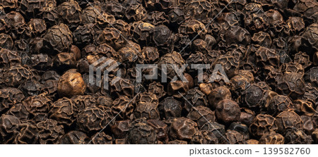 Black pepper whole grains pattern, peppercorn macro seeds closeup Black pepper whole grains pattern, peppercorn macro seeds closeup 139582760