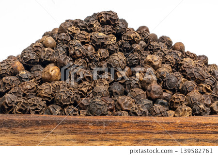 Black pepper whole grains closeup, peppercorn macro seeds 139582761