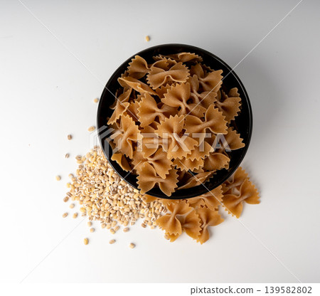 Raw Brown Farfalle Pasta Isolated Raw Brown Farfalle Pasta Isolated 139582802