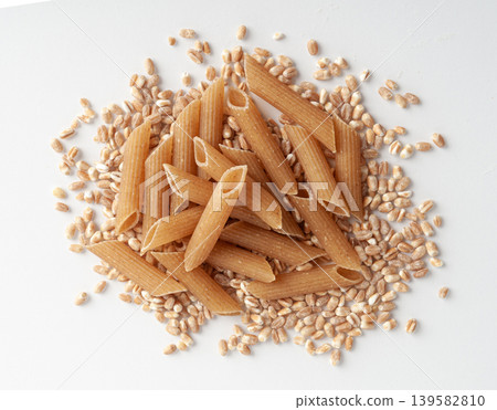 Raw Brown Pasta, Wholegrain Penne, Dry Whole Grain Noodle, Raw Spelt Macaroni, Healthy Italy Food Raw Brown Pasta, Wholegrain Penne, Dry Whole Grain Noodle, Raw Spelt Macaroni, Healthy Italy Food 139582810