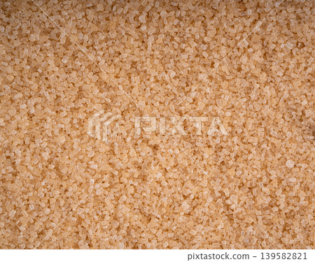 Brown cane sugar pile textured background top view Brown cane sugar pile textured background top view 139582821