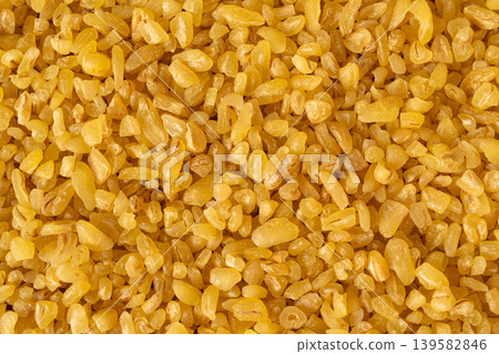 Raw bulgur closeup, dry bulghur, parboiled cracked wheat groats 139582846