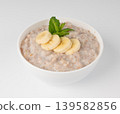 Cooked spelt in bowl isolated. Oatmeal milk porridge with fruits and berries Cooked spelt in bowl isolated. Oatmeal milk porridge with fruits and berries 139582856