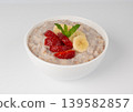 Cooked spelt in bowl isolated. Oatmeal milk porridge with fruits and berries Cooked spelt in bowl isolated. Oatmeal milk porridge with fruits and berries 139582857