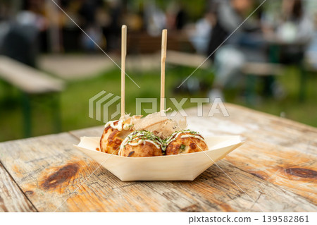 Takoyaki - traditional Japanese street food, outdoor snack with octopus Takoyaki fried balls Takoyaki - traditional Japanese street food, outdoor snack with octopus Takoyaki fried balls 139582861