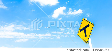 A refreshing blue sky and a T-junction sign in Biei, Hokkaido, during the summer. A refreshing blue sky and a T-junction sign in Biei, Hokkaido, during the summer. 139583044