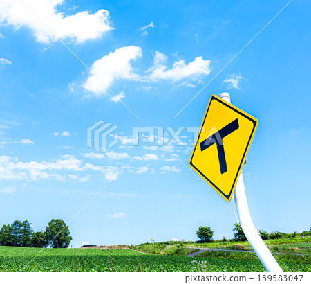 A refreshing blue sky and a T-junction sign in Biei, Hokkaido, during the summer. A refreshing blue sky and a T-junction sign in Biei, Hokkaido, during the summer. 139583047