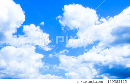 A simple and pleasant summer scene with a blue sky and white clouds. A simple and pleasant summer scene with a blue sky and white clouds. 139583115