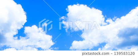 A simple and pleasant summer scene with a blue sky and white clouds. A simple and pleasant summer scene with a blue sky and white clouds. 139583120