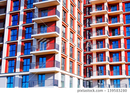 Residential building facade background, texture. Residential apartment building with winwows Residential building facade background, texture. Residential apartment building with winwows 139583280