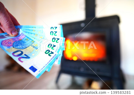 Heating payment. Save money wood stove. Euro money banknotes for payment of heating firewood Heating payment. Save money wood stove. Euro money banknotes for payment of heating firewood 139583281
