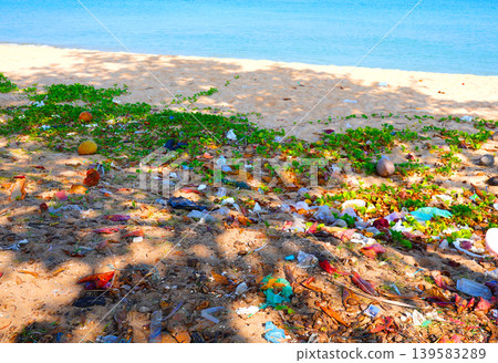 Sandy beach littered with various types of trash. Littered with plastic waste, bags Sandy beach littered with various types of trash. Littered with plastic waste, bags 139583289