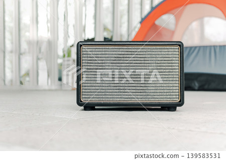 Vintage Bluetooth Speaker on Wooden Stairs in Garden with Morning Sunlight Lifestyle Concept 139583531