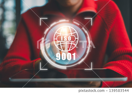 Person interacting with ISO 9001 digital interface, symbolizing quality management and business standards. Person interacting with ISO 9001 digital interface, symbolizing quality management and business standards. 139583544
