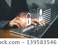 Business professional working on laptop with digital security icons, emphasizing confidentiality and data protection. 139583546