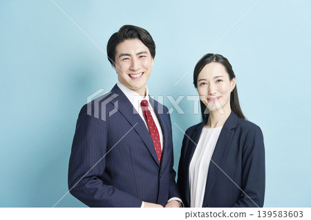 Businessmen and businesswomen standing side by side, smiling. Businessmen and businesswomen standing side by side, smiling. 139583603