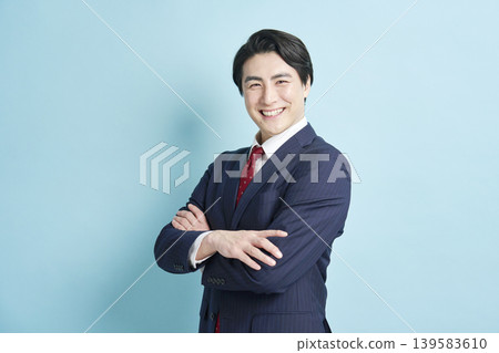 A businessman with his arms crossed and a smile on his face. A businessman with his arms crossed and a smile on his face. 139583610
