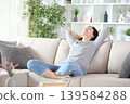 Happy asian woman relaxing on a sofa in a house 139584288