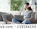 Happy asian woman watching media on personal computer 139584289