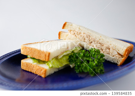 Tuna sandwich, Club sandwich, Blue plate, White background Tuna sandwich, Club sandwich, Blue plate, White background 139584835