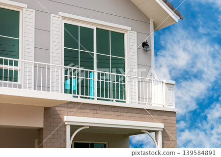 Modern Two-Story House Exterior with Blue Sky Background 139584891