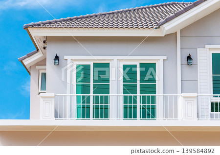 Modern Two-Story House Exterior with Blue Sky Background 139584892