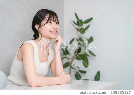 Smiling Asian woman with beautiful skin with a cheek (beauty, esthetic, skin care image) Smiling Asian woman with beautiful skin with a cheek (beauty, esthetic, skin care image) 139585127