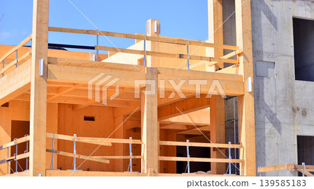 Laminate wood floors and supports of a mass timber multi story green, sustainable office building construction project. The building structure also has concrete walls. 139585183
