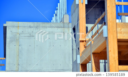 Laminate wood floors and supports of a mass timber multi story green, sustainable office building construction project. The building structure also has concrete walls. Laminate wood floors and supports of a mass timber multi story green, sustainable office building construction project. The building structure also has concrete walls. 139585189